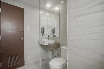 a bathroom with a toilet and a sink at Luxury Home near Solaire and Okada Manila in Manila
