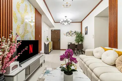a living room with a couch and a tv at Luxurious Staycation near Okada, Airport, City of Dreams, Solaire, and MOA with free pool & gym in Manila
