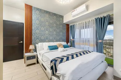 a bedroom with two beds and a window at Luxurious Staycation near Okada, Airport, City of Dreams, Solaire, and MOA with free pool & gym in Manila