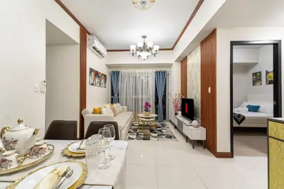 a living room with a couch and a table at Luxurious Staycation near Okada, Airport, City of Dreams, Solaire, and MOA with free pool & gym in Manila