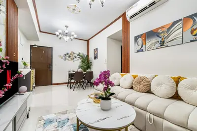 a living room with a couch and a table at Luxurious Staycation near Okada, Airport, City of Dreams, Solaire, and MOA with free pool & gym in Manila