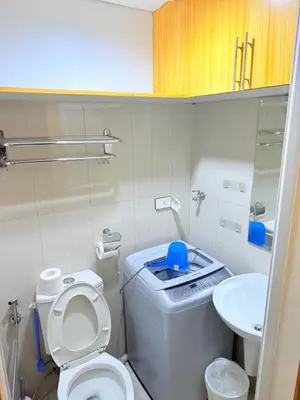 a small bathroom with a toilet and a sink at Shell Residences Prime By Paul in Manila