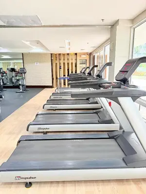 a row of treadmills in a gym at Shell Residences Prime By Paul in Manila