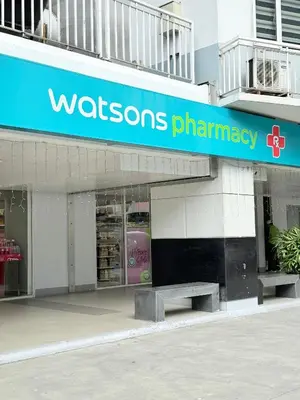 a walreens pharmacy with a bench in front of it at Shell Residences Prime By Paul in Manila