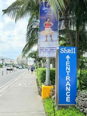 a sign on a pole next to a street at Shell Residences Prime By Paul in Manila