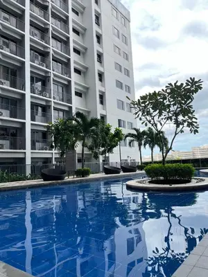 a swimming pool in front of a building at Athara Suites 2 in Manila