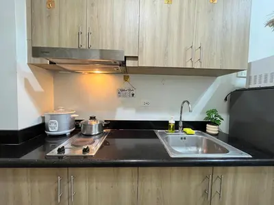 a kitchen with a sink and a counter top at Athara Suites 2 in Manila