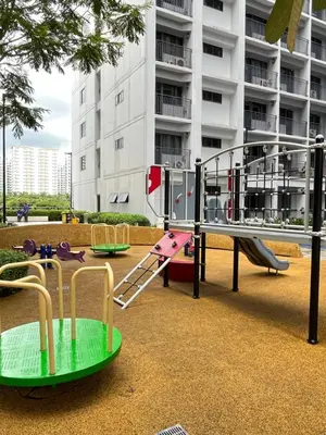 a playground in front of a building with a slide at Athara Suites 2 in Manila