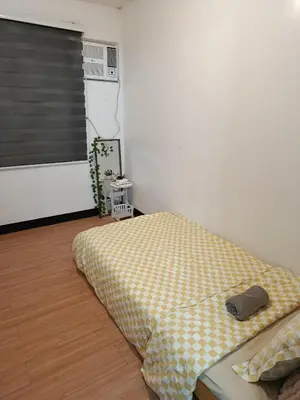 a bedroom with a bed in a room with a window at Chic Haven Home away from home in Imus