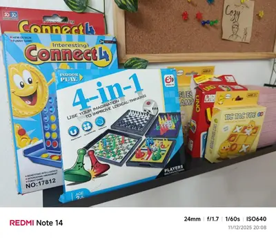 a pile of games and toys on a shelf at Chic Haven Home away from home in Imus