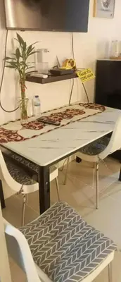 a table and chairs in a kitchen with a table at Sea Residence 2026 in Manila