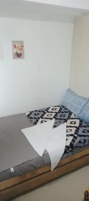a bed with a piece of paper on it at Sea Residence 2026 in Manila