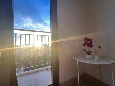 a room with a table and a window with flowers on it at 3Ms Homestay Shore in Manila