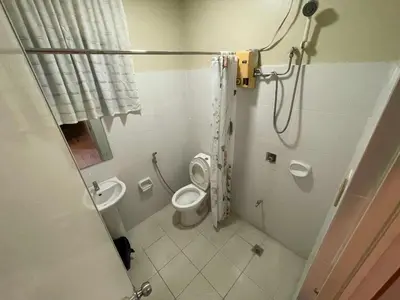 a bathroom with a shower and a toilet and a sink at Palette Gems Hotel and Conference Center in Quezon City