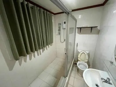 a bathroom with a shower and a toilet and a sink at Palette Gems Hotel and Conference Center in Quezon City