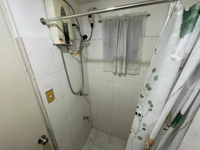 a bathroom with a shower with a shower curtain at Palette Gems Hotel and Conference Center in Quezon City