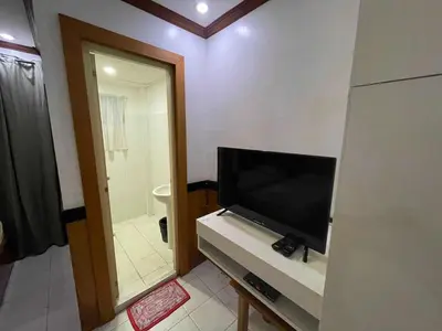a bathroom with a flat screen tv on a counter at Palette Gems Hotel and Conference Center in Quezon City