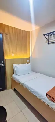 a bedroom with a white bed in a room at Stone House Hotel Manila in Manila