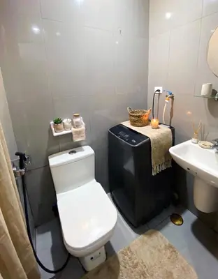 a bathroom with a toilet and a sink at Air Residences 49F City View, Wifi & Netflix in Manila