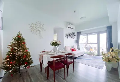 a living room with a christmas tree and a table at 2BR Luxurious Ocean View, close Okada, Solaire, MOA, Airport with free parking in Manila