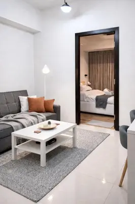 a living room with a couch and a table at Park Mckinley West Luxury 1Br Suite in Manila