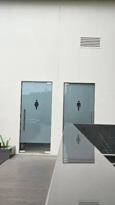 two glass doors with an apple symbol on them at Park Mckinley West Luxury 1Br Suite in Manila