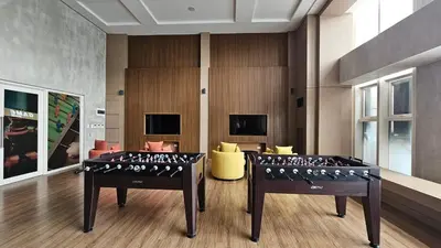 two ping pong tables in a room at Park Mckinley West Luxury 1Br Suite in Manila