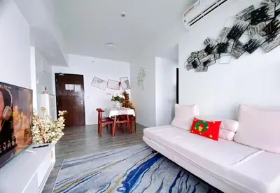 a living room with a white couch and a table at 2BR With Magnificent Bayview GARDEN View Near Okada, Solaire, Airports, Free Parking in Manila