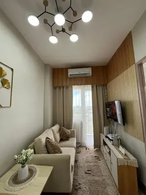 a living room with a couch and a tv at Feel at Home in Manila