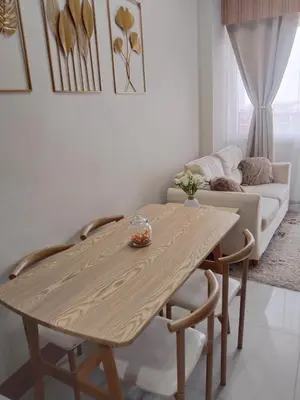 a table and chairs in a living room with a couch at Feel at Home in Manila