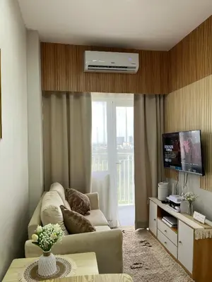 a living room with a couch and a tv at Feel at Home in Manila