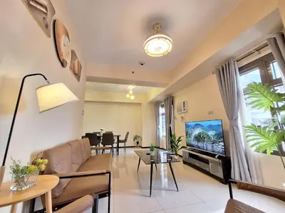 a living room with a couch and a tv at GOUTEI Homestay - The Radiance Manila Bay in Manila