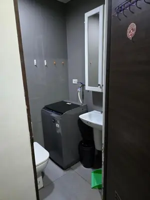 a small bathroom with a toilet and a sink at Mafresco Makati Staycation in Manila