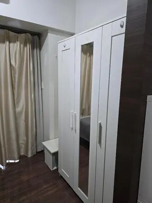 a white cabinet in a room with a shower at Mafresco Makati Staycation in Manila