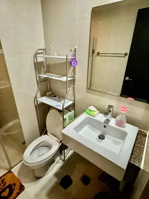 a bathroom with a white toilet and a sink at J&A CondoStay Near NAIA Terminal 3 in Manila