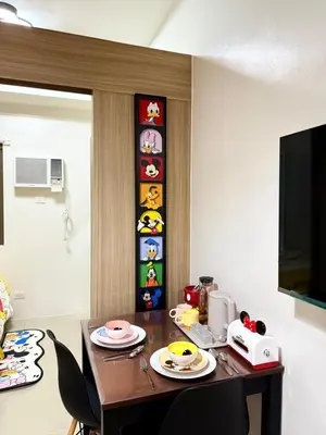 a room with a table with plates on it at Wonder Collective Stays in Manila