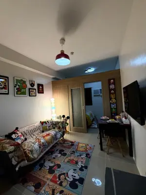 a living room with a couch and a table at Wonder Collective Stays in Manila