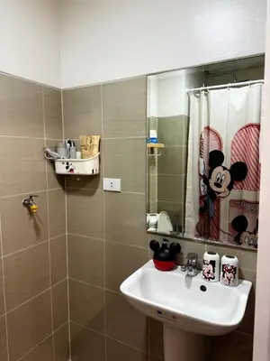 a bathroom with a sink and a mirror at Wonder Collective Stays in Manila
