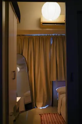 a room with a mirror and a window with a light at SMDC LIGHT Balcony Smart TV Alexa Cozy Retreat in Manila