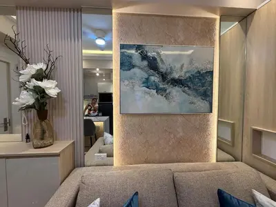 a living room with a couch and a painting on the wall at 2BR Near Manila Bay MOA l Airport with FREE use of Pool l 4 PPL in Manila