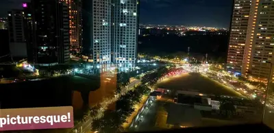 a view of a city at night with lights at BGC Forbes Area Your Home Away From Home in the Heart of BGC with hi-speed Wi-Fi PrimeVideo,Disney ,Netflix in Manila
