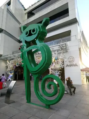 a green statue of a snake in front of a building at BGC Forbes Area Your Home Away From Home in the Heart of BGC with hi-speed Wi-Fi PrimeVideo,Disney ,Netflix in Manila