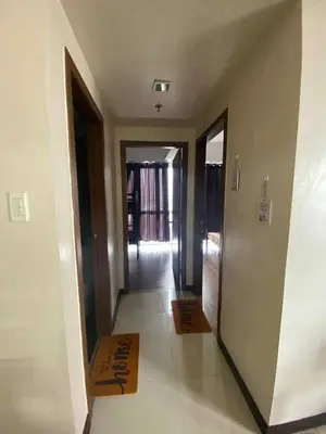 a hallway with a hallway leading to a room at Staycation by Capri in Manila