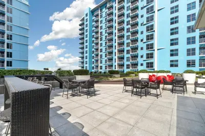 a patio with chairs and tables in front of a building at Seaview 2BR CondoteI Near Airport,NAIA, MOA ,Okada Casino in Manila