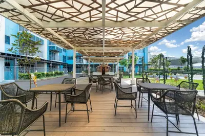 an outdoor patio with tables and chairs and a fountain at Seaview 2BR CondoteI Near Airport,NAIA, MOA ,Okada Casino in Manila