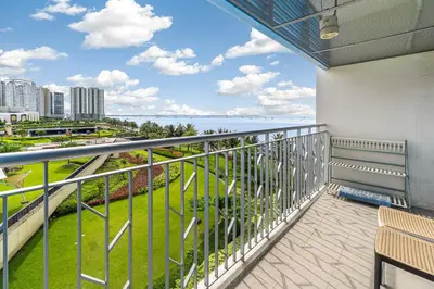 a balcony with a view of the ocean at Seaview 2BR CondoteI Near Airport,NAIA, MOA ,Okada Casino in Manila