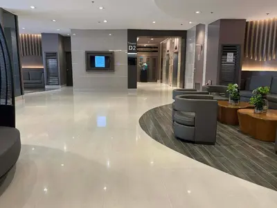 a lobby with couches and a tv in a building at Shore Balcony MOA Price worthy Wifi Pool Netflix in Manila