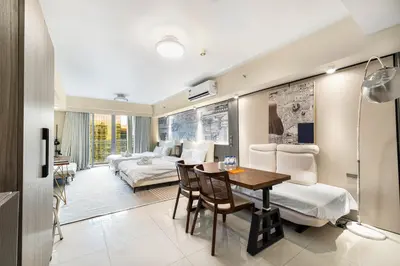 a room with two beds and a table and chairs at Cozy Family Suite with City View near City of Dreams Casino, Airport, Solaire, Okada, Ayala Malls and MOA in Manila
