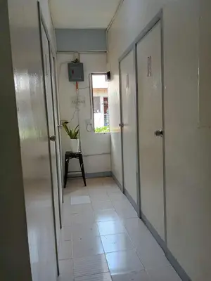 an empty hallway with a door and a window at SL Bedspace Transient House in Manila