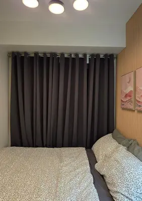 a bedroom with a bed and a black curtain at Posh & Chic Suite 1 Bedroom Mall of Asia Airport in Manila